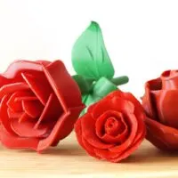 four 3d printed roses in red plastic
